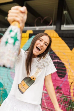 QUEEN OF SPARKLES WHITE CHAMPAGNE TEE -Western Cowboy Clothing Store image 720x d590a1d6 606a 492d b313 fd220337358c